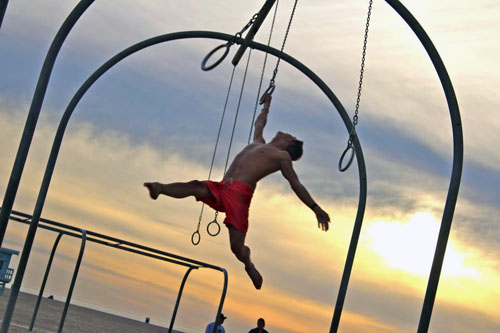 Steve on the traveling rings looking up enough to create a nice arch. (Photo by Phyllis Osman)